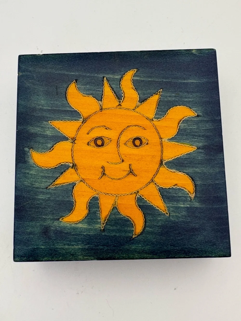Bright Yellow Sun on Deep Blue Wooden Box